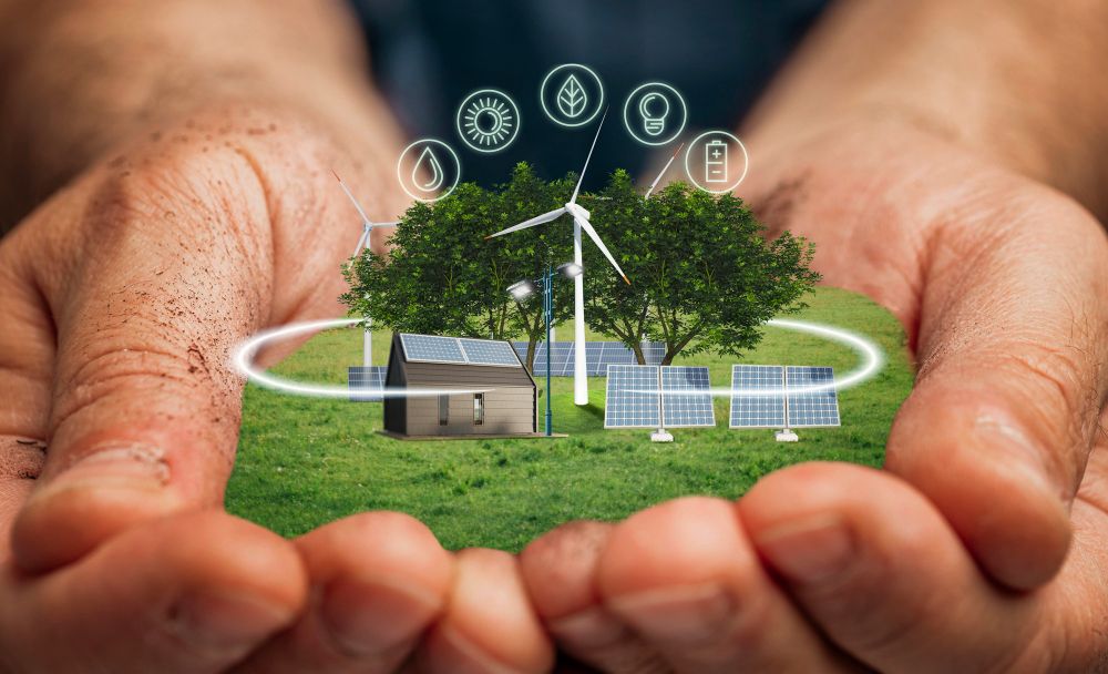 Hands holding a green landscape with a solar-powered home and wind turbine