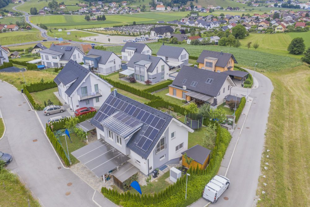 Aerial view of a suburb with solar panels on many roofs
